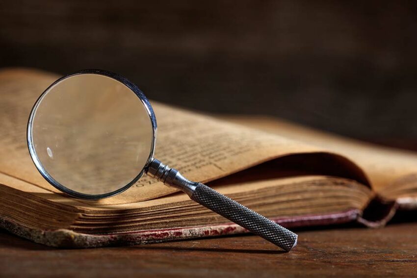 Magnifying glass and a vintage book